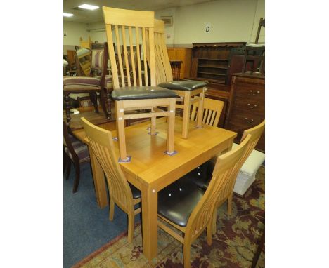 A modern light oak extending dining table and six chairs