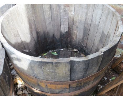 A very large half barrel oak garden planter