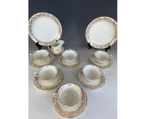 A 1930s Royal Worcester tea set for six, comprising tea cups and saucers, a milk jug, two serving dishes and six cake plates