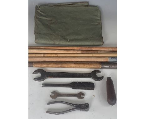 A Wartime military groundsheet, tent pegs and British army issue pincers and other tools