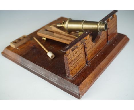 A turned-brass scale model Carronade canon modelled set on a ship's deck, 21 cm x 21 cm