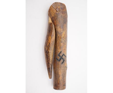 A primitive carved wooden pipe tamper bearing a swastika