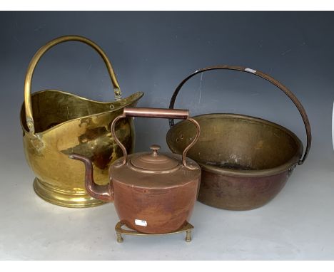 A Victorian brass coal helmet, copper kettle, brass jam pan and iron stand / trivet