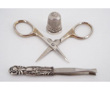 An early 20th Century silver thimble, 1953 Coronation commemorative scissors and tweezers