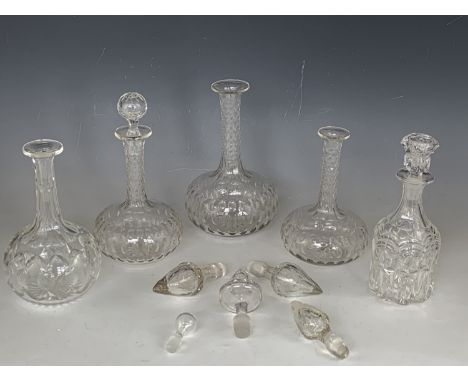 Four Victorian cut glass shaft-and-globe decanters, one other Victorian decanter and several associated stoppers