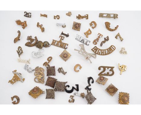 A quantity of British army shoulder titles, badges etc