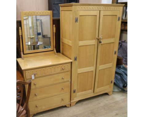 A panelled light oak two door wardrobe and matching dressing chest (2)