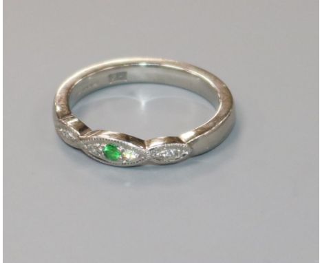 A modern platinum, green sapphire? and diamond ring,