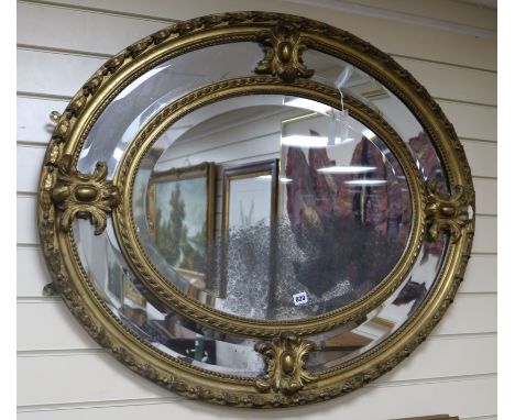 A 19th century giltwood and gesso oval marginal plate mirror W.100cm