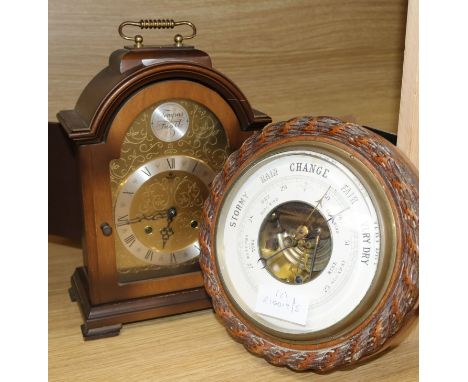 An oak-cased aneroid barometer and a later mantel clock