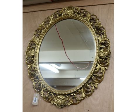 A 19th century Florentine oval carved gilt-framed mirror H.66cm