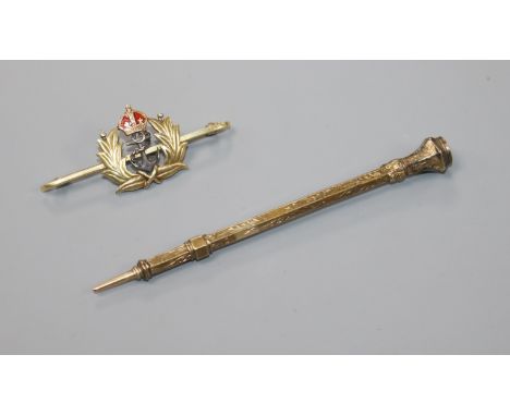 A 15ct gold and enamel bar brooch and a yellow metal overlaid propelling pencil.