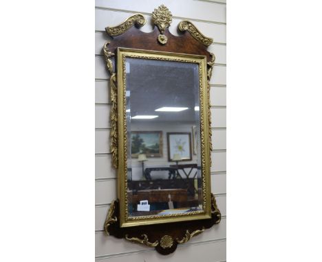 A George III style walnut and parcel gilt fret-cut mirror H.104cm