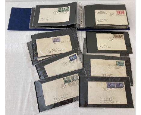 A blue album containing 80 assorted American first day covers from the 1950's.  