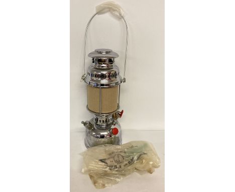 A new chrome Tilley lamp with accessories.  