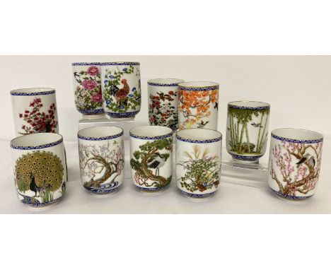 A collection of 11 Franklin Mint ceramic Japanese tea cups. Each with a different bird and floral design. Each approx. 8.25cm