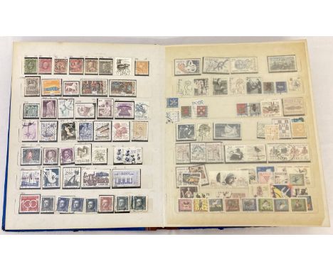 A blue vintage stamp stock book containing world stamps. Includes examples from: Spain, Turkey, USA and Vietnam. 