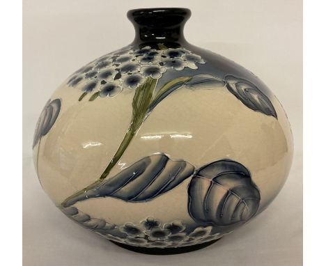 A large Moorcroft style ceramic short necked vase of bulbous form &amp; blue and cream colouration.  Approx. 28cm tall x 32cm