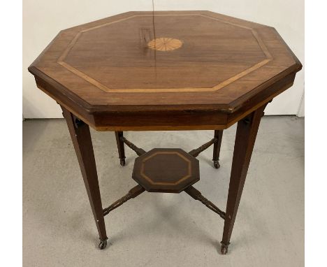 An Edwardian hexagonal occasional table with inlay detail to top. on tapered legs and with lower shelf, turned supports and o