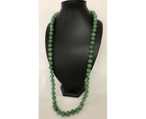 A 33" apple green jade beaded necklace, knotted between each bead.  Beads approx. 1.25cm diameter.