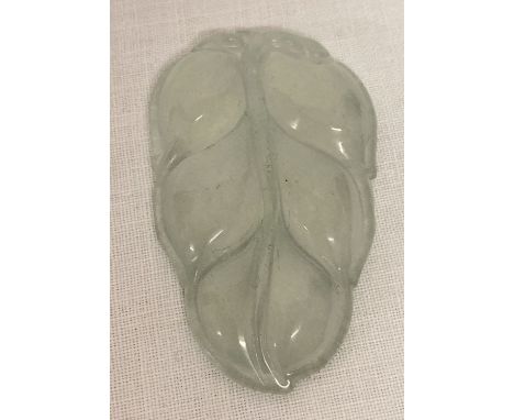 A carved ice jade pendant in the shape of a leaf. Very small hole present to the base of the leaf. Approx. 5.75 x 3.5cm.