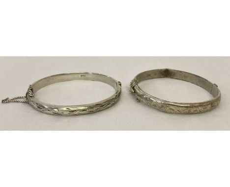 2 vintage silver hinged bangles with safety chains and half floral decoration. 1 bangle a/f. Hallmarked Birmingham 1957 and 1