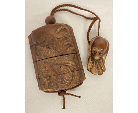 A Chinese carved hardwood Inro; stacking snuff/spice box. With swimming fish detail to each side and carved Octopus shaped pe