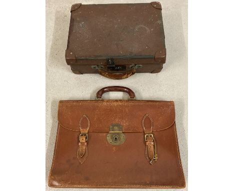 A vintage small leather suitcase together with a leather briefcase with brass fixing and buckles.  