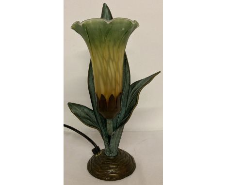 A Tiffany style table lamp in the shape of a lily. Cast metal leaves with brown, yellow and green glass fluted flower shaped 