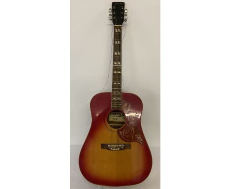 A vintage Laramie acoustic guitar with hummingbird decoration to pick guard and red finish to body. Needs new strings. Comes 