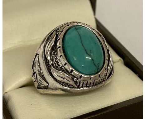 A chunky white metal dress ring set with oval turquoise cabochon.  Ring size R.