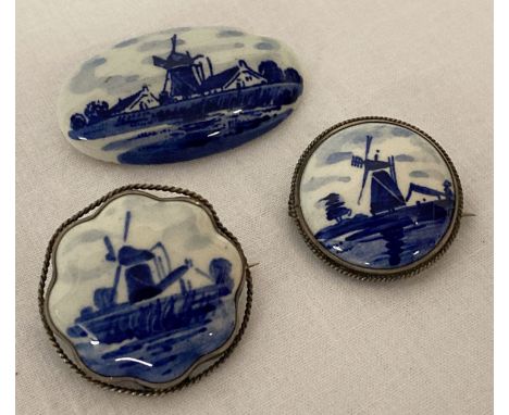 3 delft ceramic brooches depicting windmills. 2 vintage Delft Ware brooches with silver mounts, together with a modern delft 