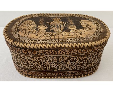 A burnt light wood round ended box, possibly Eastern European.  Approx. 14 x 31 x 18cm.
