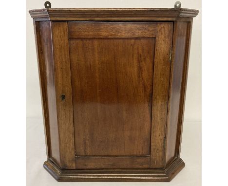 A small vintage mahogany wall hanging corner cupboard with interior shelf.  Approx. 35cm wide  x 39cm tall.