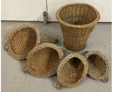 A set of 4 graduating size wicker cornucopia baskets together with a vintage cane waste paper basket  