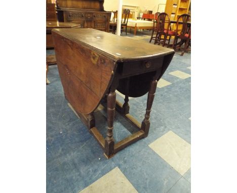 An Early 19 Century Oak Drop Leaf Gate Leg Dining Table with End Drawers.