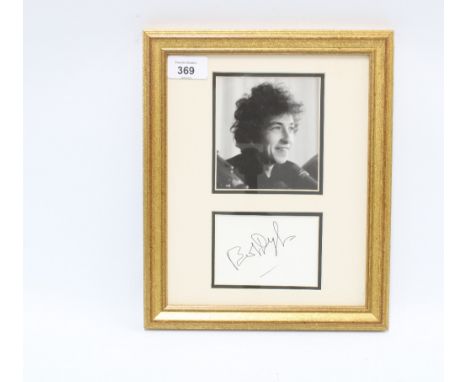 Bob Dylan autograph on white card and signed in black ink mounted with a black and white photograph and framed under glass, s