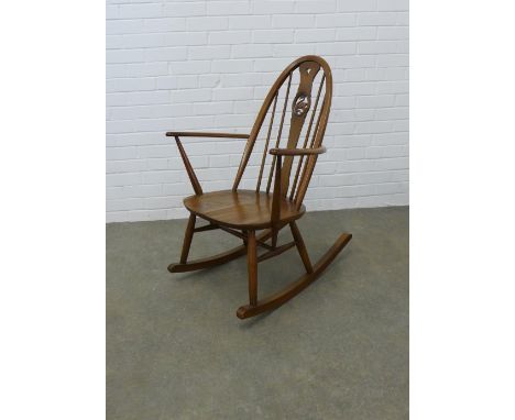 An Ercol elm and beech rocking chair with swan splat back. 92 x 65cm 