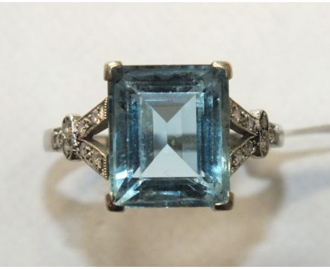 An Art Deco aquamarine and diamond ring claw-set a rectangular-cut aquamarine of approximately 4cts between split shoulders s