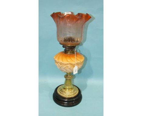 A Victorian brass oil lamp with etched frilly glass shade and moulded glass reservoir, raised on a ceramic plinth, 52cm high.