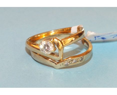 A solitaire diamond ring, claw set a brilliant cut diamond of approximately 0.4cts in 18ct yellow gold asymmetric mount, and 