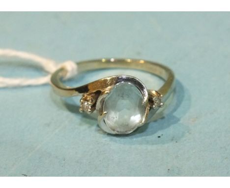 A 14k white gold cross-over ring set an oval aquamarine and two diamond points, size L½, 2.8g.