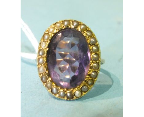 A 9ct gold ring set a large amethyst within a surround of seed pearls, size M, 6.2g.