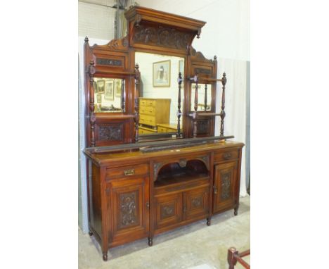 A Late-Victorian walnut sideboard, the back with central bevelled rectangular mirror flanked by two smaller mirrors and shelv