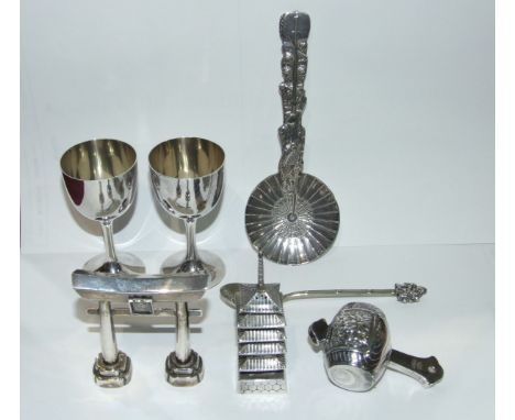 A sterling silver pepper in the form of a pagoda, a white metal pepper in the form of a Japanese arch and other Japanese whit