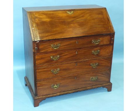 An early-19th century mahogany bureau, the fall front opening to reveal pigeon holes and drawers above four graduated drawers
