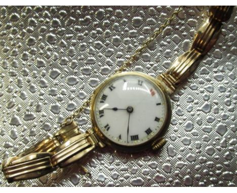 Early C20th ladies Swiss 9ct gold cocktail wristwatch, white enamel Roman dial with dot minute indices, hinged bezel and back