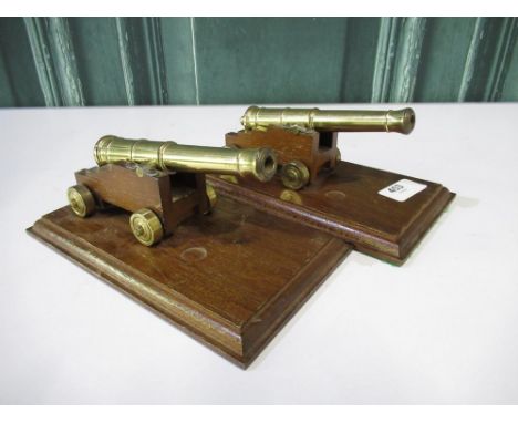 Pair of scale model cannons with 6" barrels on wooden plinths 