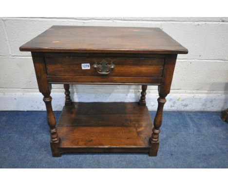 A REPRODUCTION OAK LAMP TABLE, with a single frieze drawer, on turned legs, united by an undershelf, width 62cm x depth 46cm 