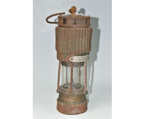 A VINTAGE PATTERSON TYPE MINER'S LAMP, in rusted condition, lettering to top indistinct, bears stamped '92' to applied metal 